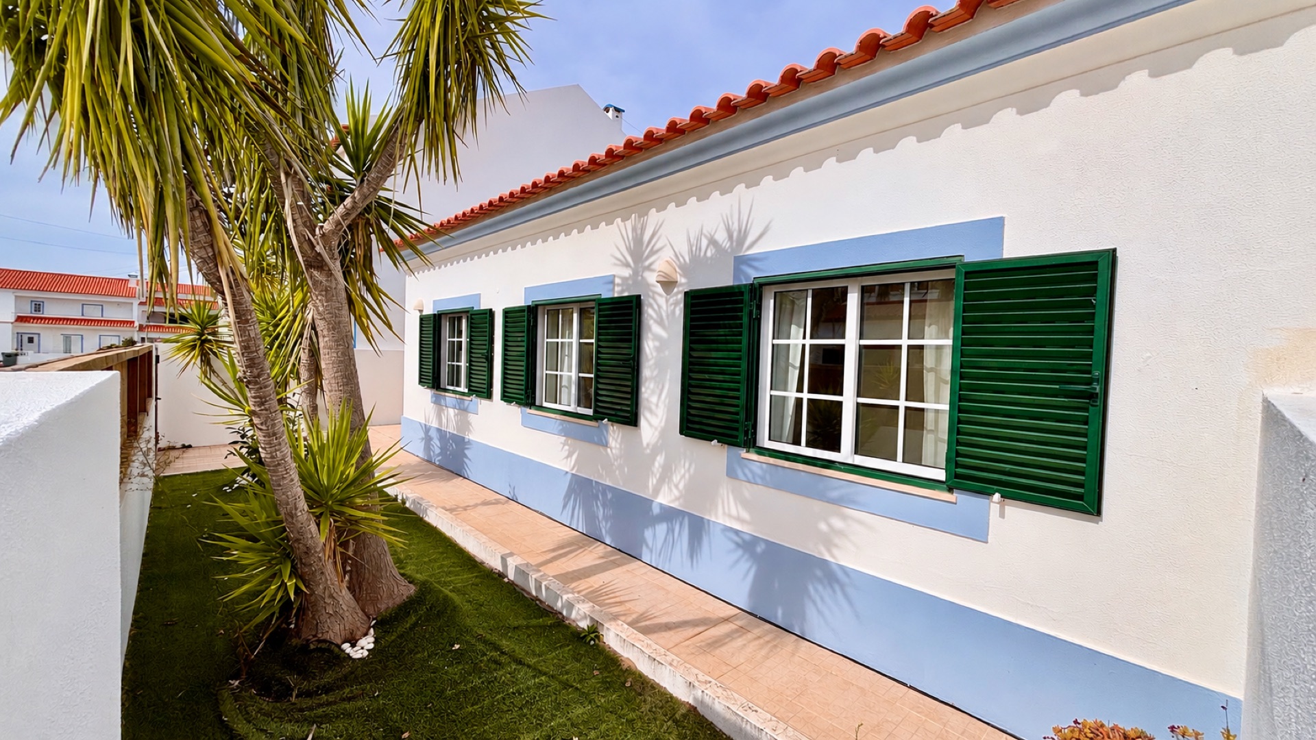 Casa do Mar white exterior facade with green shutters